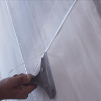 remove-the-excess-grout-with-a-blade-screapper
